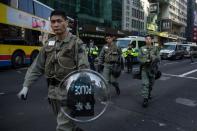 Hong Kong riot police walk along a cordoned-off street on February 9, 2016 following clashes in the city