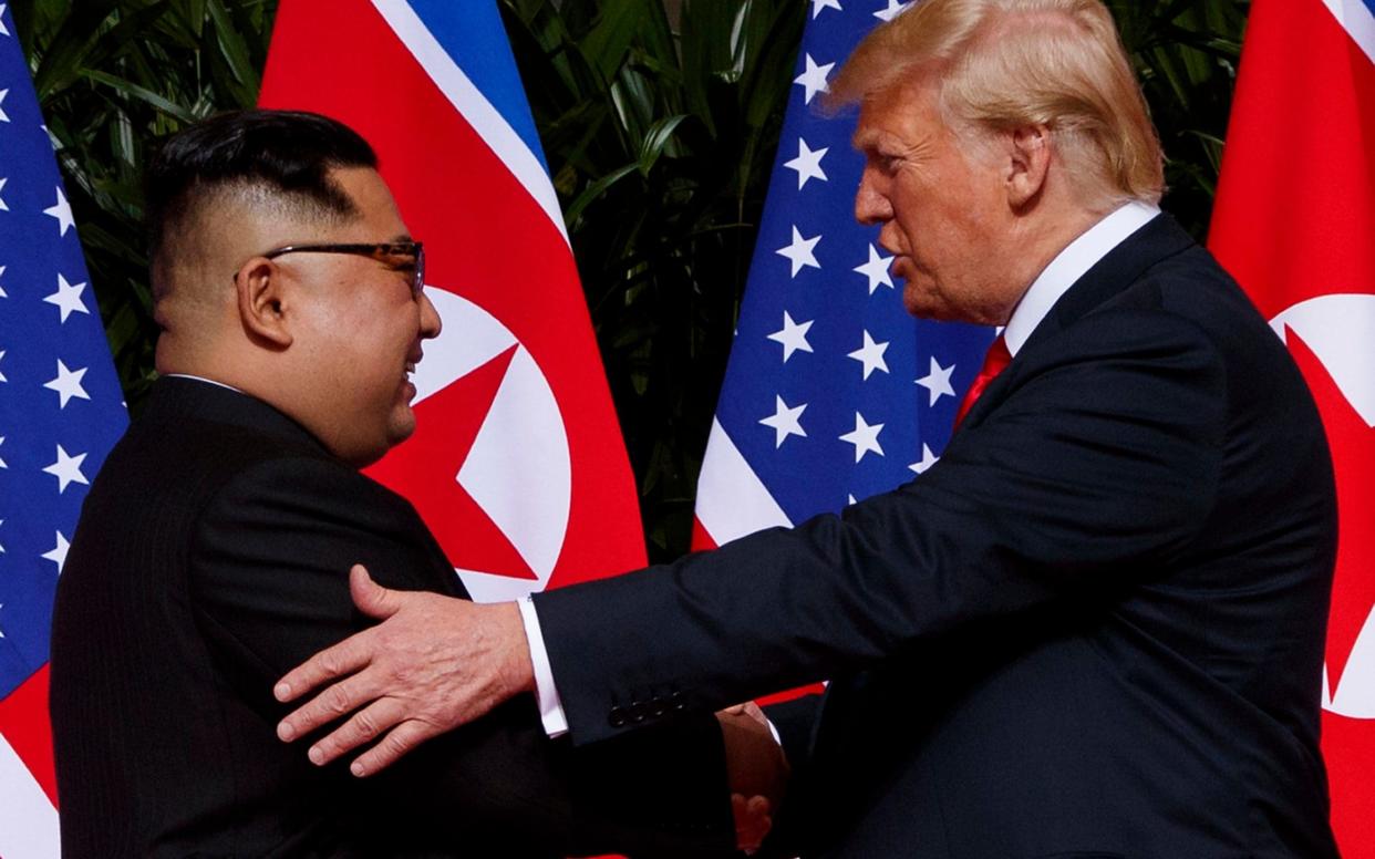 President Donald Trump meets with North Korean leader Kim Jong Un on Sentosa Island, Tuesday, June 12 - AP