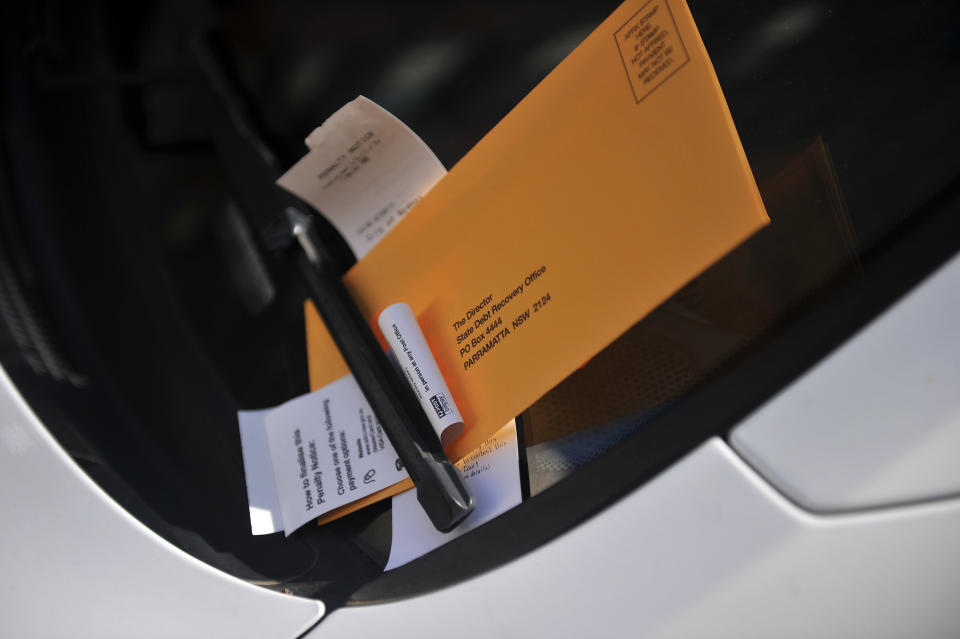 Parking fines are pictured stuck onto a car's windshield. Source: AAP