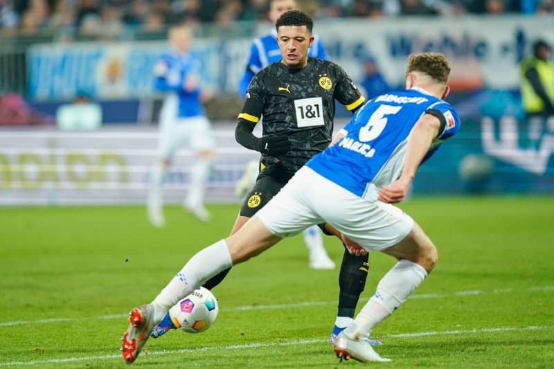 Borussia Dortmund's Jadon Sancho (back) and Darmstadt's Matej Maglica battle for the ball during the German Bundesliga soccer match between Darmstadt 98 and Borussia Dortmund at Merck Stadium. Uwe Anspach/dpa