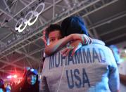 <p>U.S. fencer Ibtihaj Muhammad hugs her nephew, Zayd Muhammad, after the U.S. defeated Italy for the bronze medal in Team Sabre competition on Saturday, Aug. 13, 2016, at the Olympic Games in Rio de Janeiro, Brazil. (Mark Reis/Colorado Springs Gazette/TNS via Getty Images) </p>