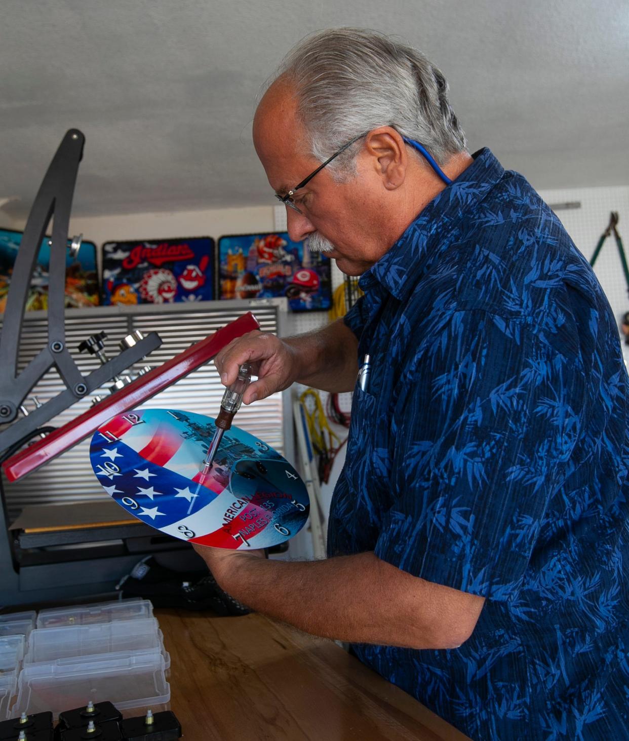 Award-winning Cape Coral-based graphic artist Girard Moravcik, owner of Colorful Creations by GJM, creates highly colorful metallic pieces in his home garage.