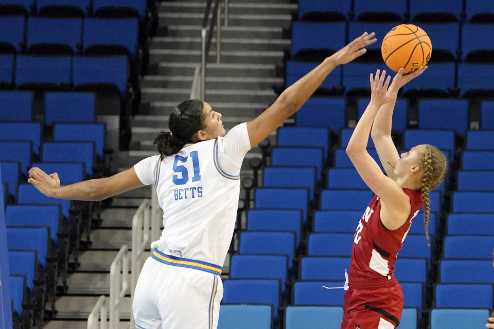 Cal State Northridge guard Erica Adams, right, shoots as UCLA center Lauren Betts defends during the first half of an NCAA college basketball game Thursday, Dec. 7, 2023, in Los Angeles. (AP Photo/Mark J. Terrill)