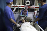 File - In this Saturday, May 8, 2021 file photo, an Afghan school student is treated at a hospital after a bomb explosion near a school west of Kabul, Afghanistan, Saturday, May 8, 2021. The May 8 triple bombing of the Syed-Al-Shahada girls school that killed more than 100, nearly 80 of them Hazara students (AP Photo/Rahmat Gul, File)