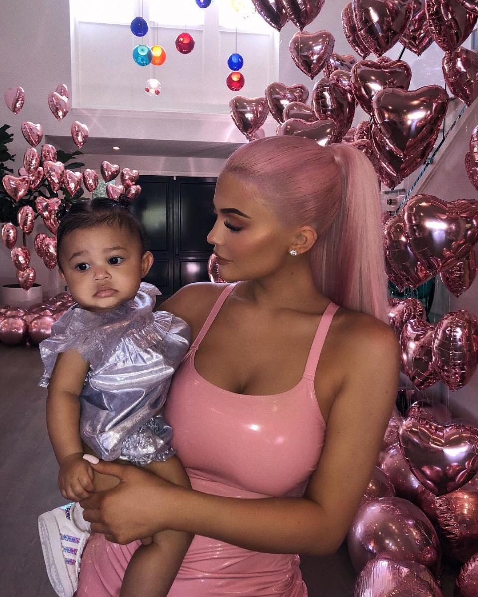 <p>This pink number is the ultimate party dress, here’s Kylie holding daughter Stormi. Photo: Instagram @kyliejenner </p>