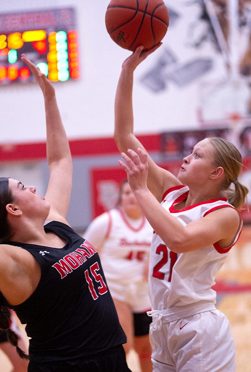 Buckeye Central's Nevaeh Metzger floats a shot over Mohawk's Mia Miller.