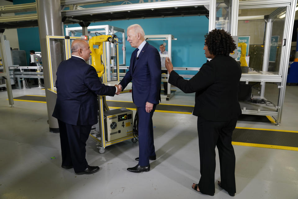 President Joe Biden shakes a persons hand as he tours the Cuyahoga Community College Manufacturing Technology Center, Thursday, May 27, 2021, in Cleveland. (AP Photo/Evan Vucci)