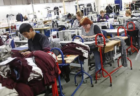 Employees work on sewing machines at the Fashion Enter factory in London England, January 8, 2016. REUTERS/Eddie Keogh