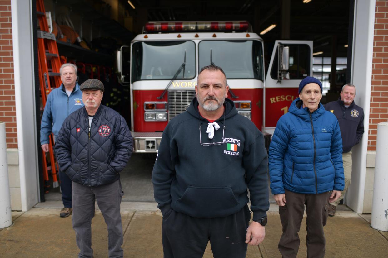 Retired firefighter Paul Cotter, center, and from left, David Ford, Mark Whalen, Bill Bernhard and Rob Pastor outside of the Franklin Street Fire Station.