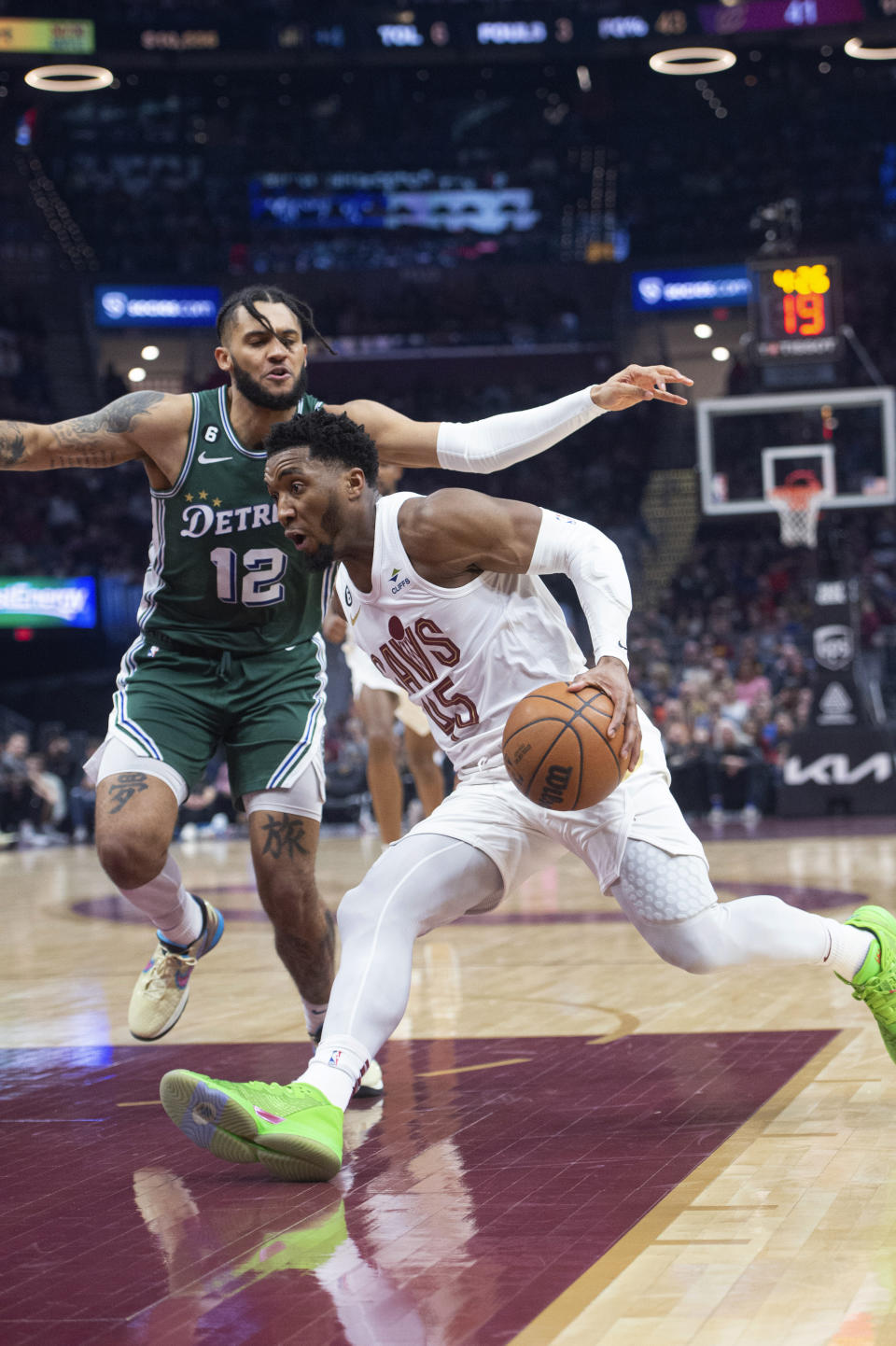 Cleveland Cavaliers' Donovan Mitchell (45) drives past Detroit Pistons' Isaiah Livers during the first half of an NBA basketball game in Cleveland, Saturday, March 4, 2023. (AP Photo/Phil Long)