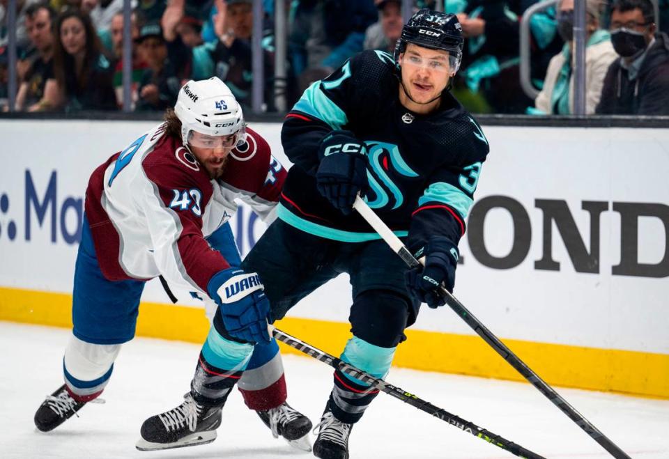 Seattle Kraken goaltender Philipp Grubauer (31) passes the puck as Colorado Avalanche defenseman Samuel Girard (49) tries to intercept him during the first period of a first round 2023 Stanley Cup Playoffs game against the Colorado Avalanches at Climate Pledge Arena in Seattle on Saturday, April 22, 2023. The Seattle Kraken lost 4-6 to the Colorado Avalanches.