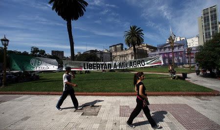 People walk by a banner that reads "Free (leader of the Tupac Amaru social welfare group) Milagro Sala" outside a Justice building in Buenos Aires, Argentina, December 28, 2016. REUTERS/Marcos Brindicci