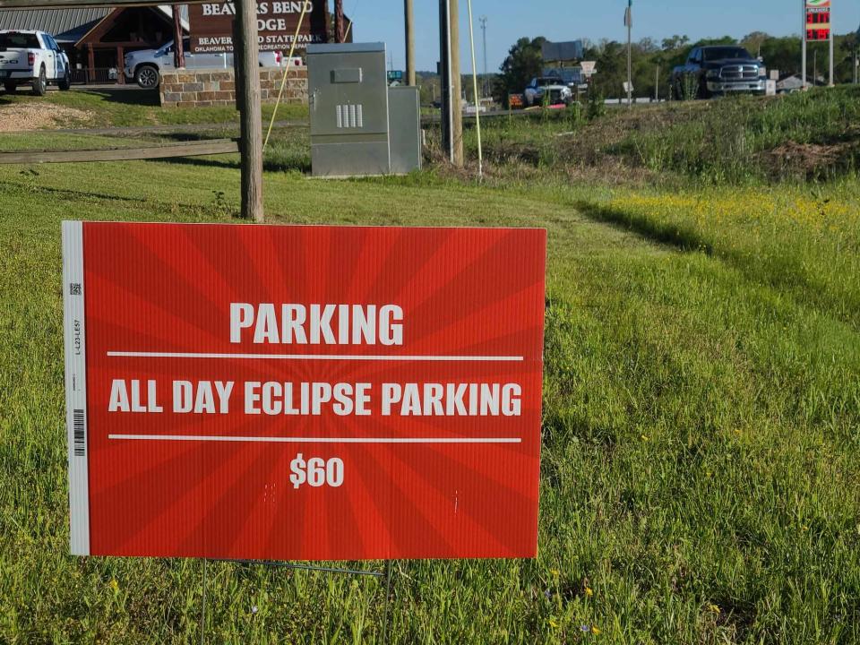 A sign advertises all-day parking for Monday's total solar eclipse in Hochatown, Oklahoma.