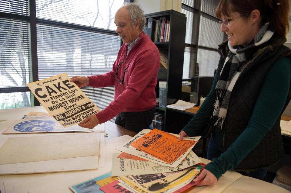 James Fox and Lynn Brennan look through a collection of rock ‘n’ roll posters in 2019 in the Gerth Special Collections & University Archives at Sacramento State.