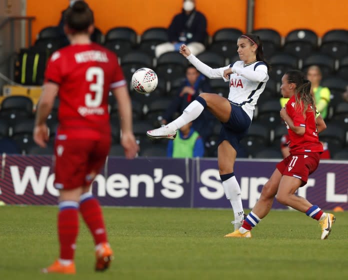 Tottenham Hotspur's Alex Morgan, center, vies for the ball with Reading's Natasha Harding during the English Women's Super League soccer match between Tottenham Hotspur and Reading at the Hive stadium in London Saturday, Nov. 7, 2020. Morgan came on as a 69th minute substitute, the game ended in a 1-1 draw. (AP Photo/Alastair Grant)