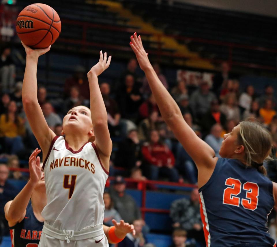 Harrison Raiders forward Riley Whitlock (23) defends the shot of McCutcheon Mavericks forward Marley Dale (4) during the IHSAA girl’s basketball sectional championship game, Saturday, Feb. 3, 2024, at Kokomo Memorial Gymnasium in Kokomo, Ind.