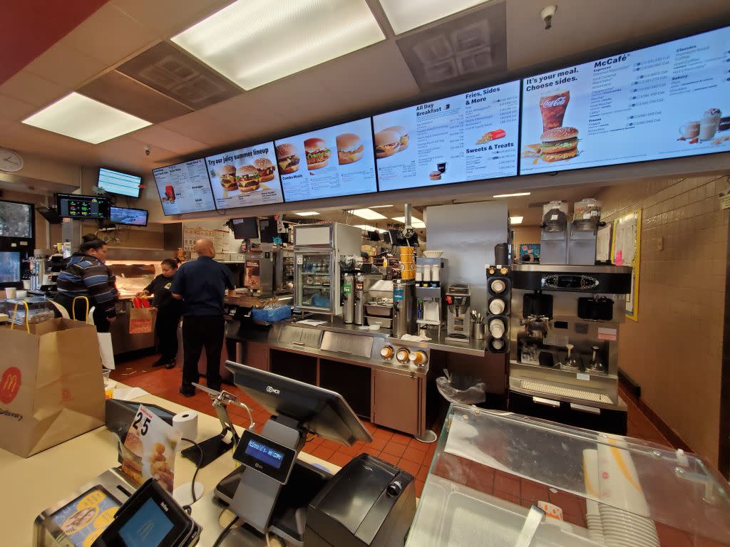  Counter area, kitchen and menus are visible in wide angle view in interior of McDonald's restaurant in San Ramon, California. 