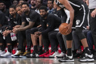 Brooklyn Nets guard Kyrie Irving, center, watches action against the Sesi/Franca Basketball Club from the bench during the first half of an exhibition NBA basketball game, Friday, Oct. 4, 2019, in New York. (AP Photo/Mary Altaffer)