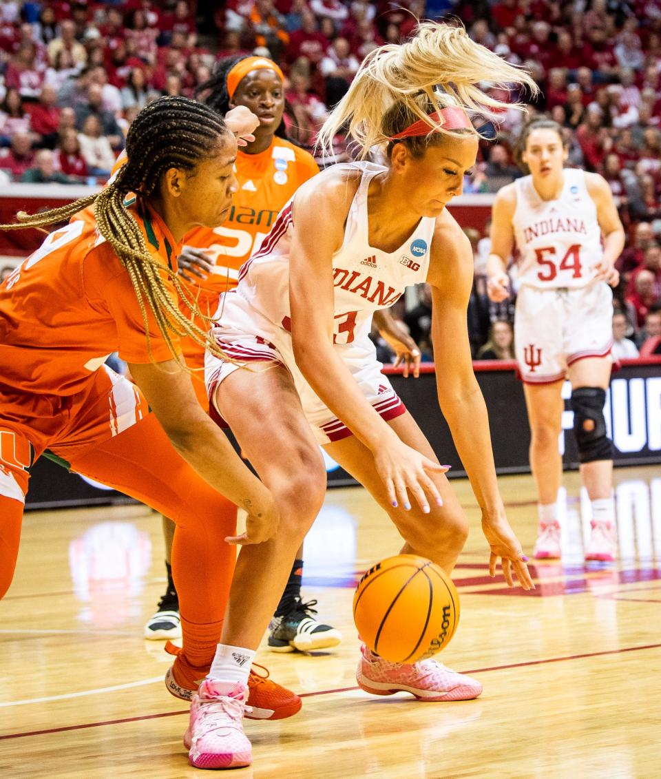 Miami (FL)'s Jasmyne Roberts (4) knocks the ball loose from Indiana's Sydney Parrish (33) during the first half of Monday's second-round NCAA Tournament game.