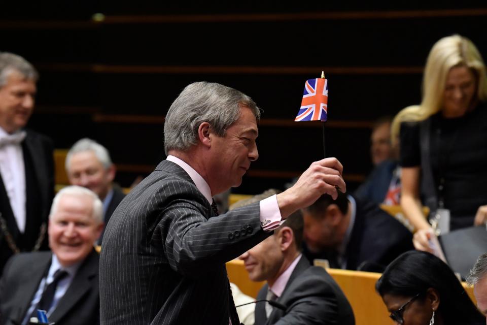 Britain's Brexit Party leader Nigel Farage waves a union flag  during a European Parliament plenary session in Brussels on January 29, 2020, as Brexit Day is to be set in stone when the European Parliament casts a vote ratifying the terms of Britain's divorce deal from the EU. (Photo by JOHN THYS / AFP) (Photo by JOHN THYS/AFP via Getty Images)