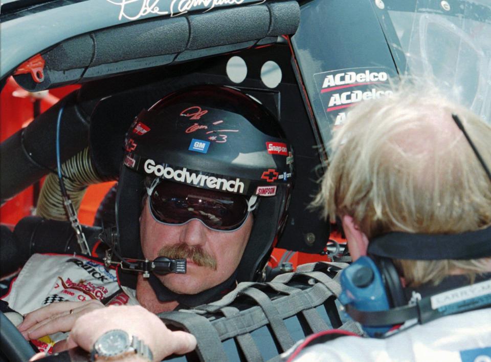 Dale Earnhardt talks with then-crew chief Larry McReynolds at Michigan Speedway in 1997.