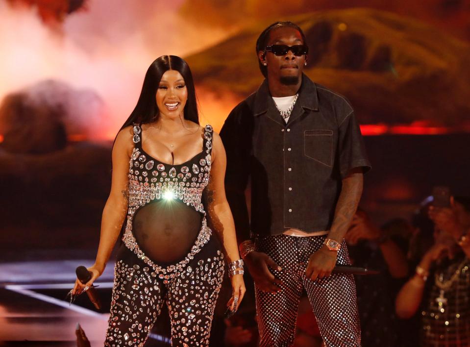 Cardi B and Offset onstage at the 2021 BET Awards to reveal their pregnancy.