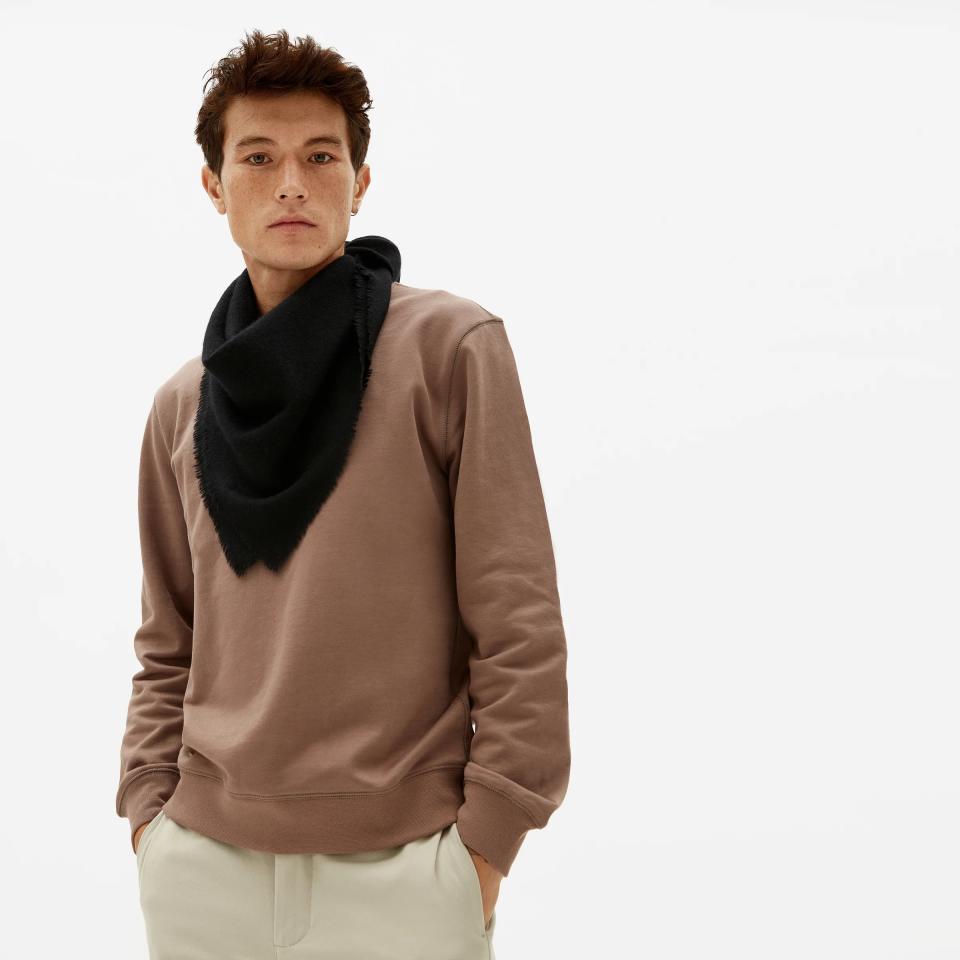 A guy wearing a brown sweater and black cashmere bandana