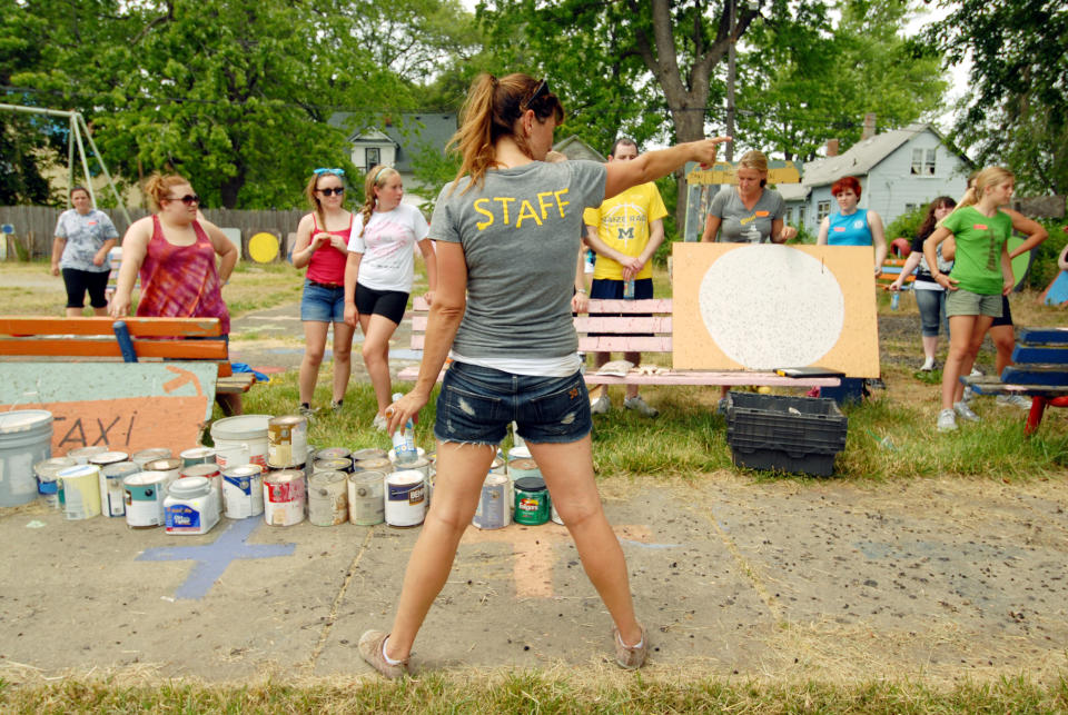 DETROIT, MI - JUNE 16: Volunteers help clean up abandoned homes as part of the Foster the People, Foster the Future: Do Good Project at Heidelberg Project on June 16, 2012 in Detroit, Michigan. (Photo by Paul Warner/Getty Images)