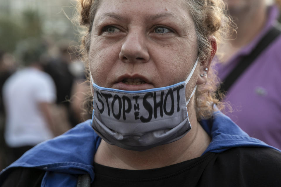 An anti-vaccine protester shouts slogans during a rally at central Syntagma square, in Athens, Greece, Sunday, Aug. 29, 2021. Police used tear gas to disperse thousands of protesters opposing government's plans for mandatory vaccination and new testing requirements and attendance restrictions on people who aren't vaccinated against COVID-19. (AP Photo/Yorgos Karahalis)
