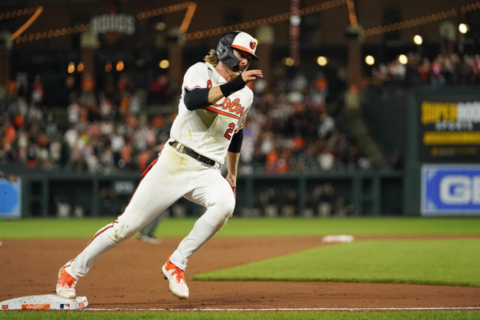 Baltimore Orioles' Gunnar Henderson runs the bases while scoring on a bases-loaded double by Anthony Santander off Chicago White Sox relief pitcher Aaron Bummer during the seventh inning of a baseball game, Tuesday, Aug. 29, 2023, in Baltimore. Orioles' Ryan McKenna and Adley Rutschman also scored on the double. (AP Photo/Julio Cortez)