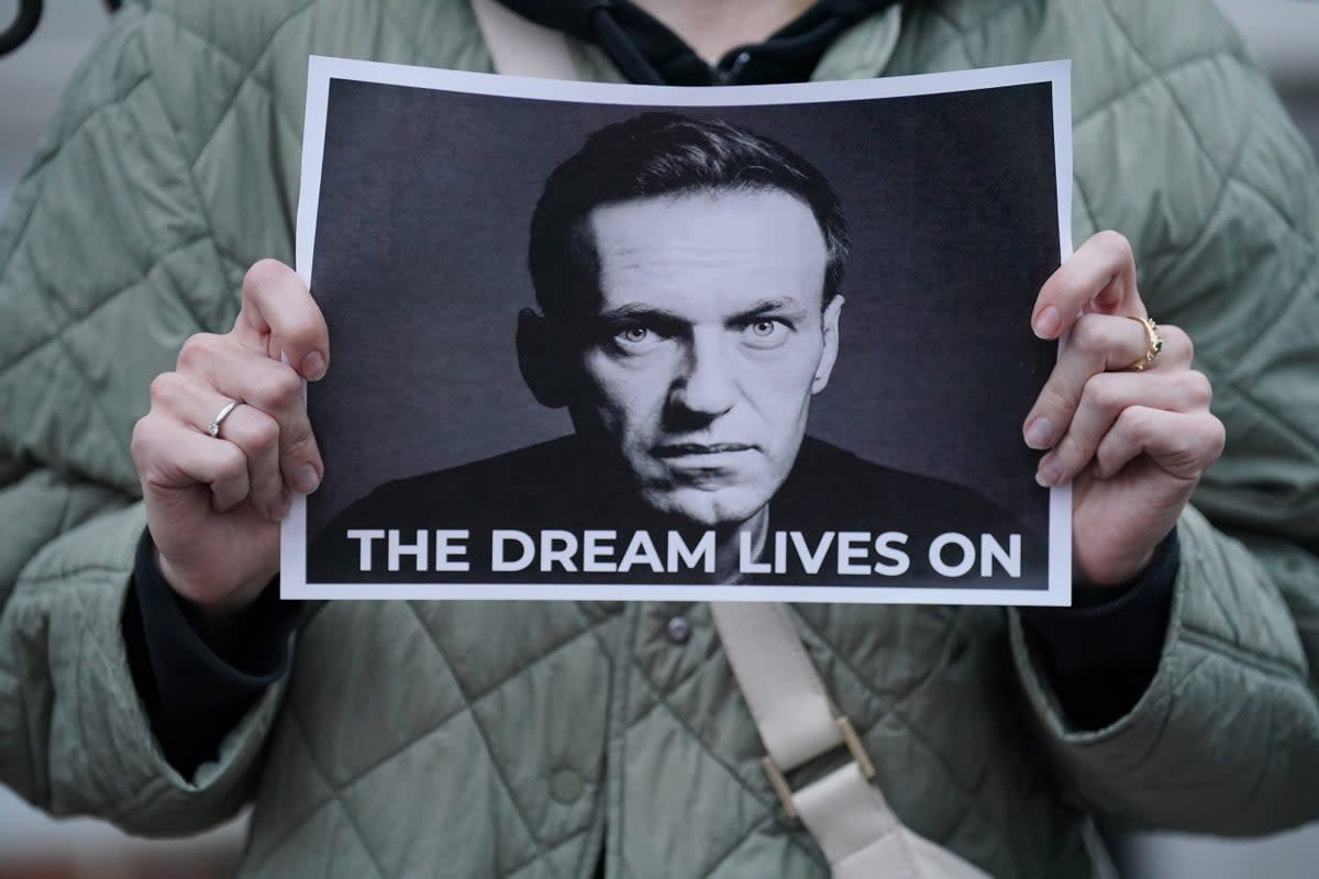 A protester holds a picture of Navalny at a protest opposite the Russian embassy in London (PA Wire)