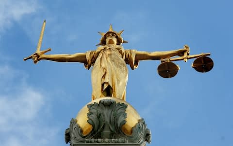 Lady Justice, holding scales and a sword, on top of the Central Criminal Court - Credit: Clara Molden/PA