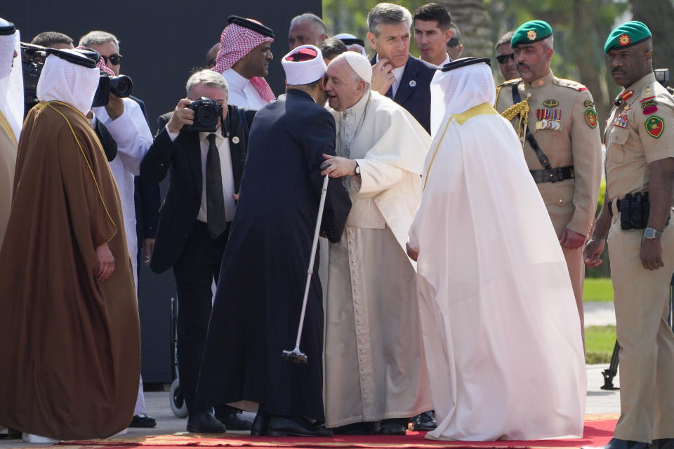 Pope Francis is welcomed by Ahmed El-Tayeb, Grand Imam of al-Azhar, as he arrives to attend the closing session of the "Bahrain Forum for Dialogue: East and west for Human Coexistence", at the Al-Fida square at the Sakhir Royal palace, Bahrain, Friday, Nov. 4, 2022. Pope Francis is making the November 3-6 visit to participate in a government-sponsored conference on East-West dialogue and to minister to Bahrain's tiny Catholic community, part of his effort to pursue dialogue with the Muslim world. (AP Photo/Hussein Malla)