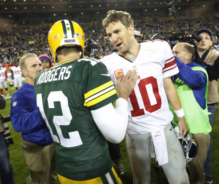 Eli Manning and Aaron Rodgers square off again in the playoffs. (AP)