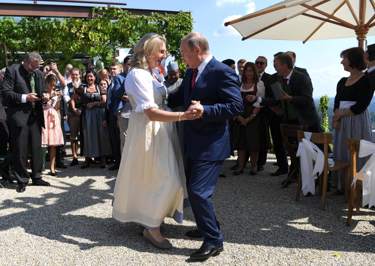 Austrian Foreign Minister Karin Kneissl and Russian President Vladimir Putin dance during her wedding on August 18, 2018 in Gamlitz, Styria, Austria.