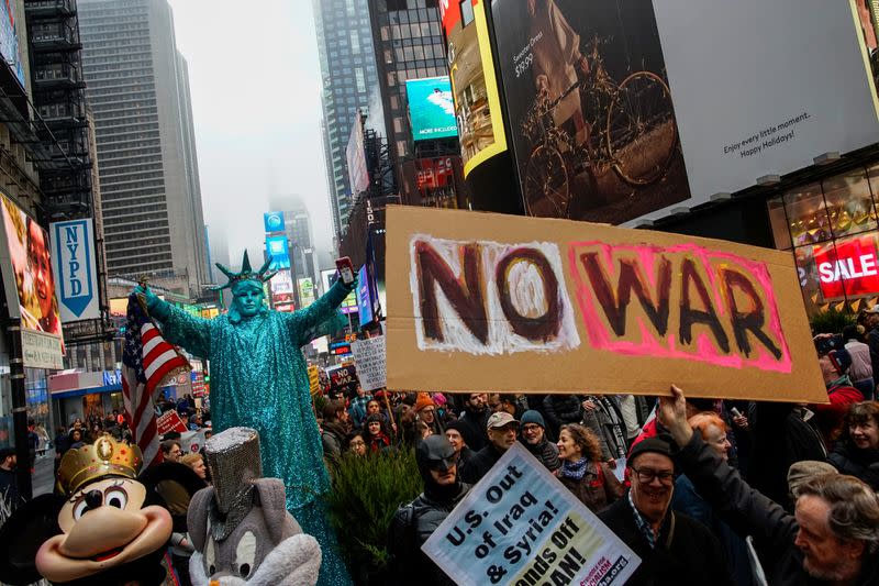 People march as they take part in an anti-war protest amid increased tensions between the United States and Iran at Times Square in New York