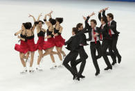 In this multiple exposure photo, Nathalie Pechalat and Fabian Bourzat of France compete in the team ice dance short dance figure skating competition at the Iceberg Skating Palace during the 2014 Winter Olympics, Saturday, Feb. 8, 2014, in Sochi, Russia. (AP Photo/Bernat Armangue)