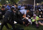 Police arrest pro-Palestinian protesters attempting to camp on Washington University's campus, Saturday, April 27, 2024, in St. Louis, Mo. (Christine Tannous/St. Louis Post-Dispatch via AP)