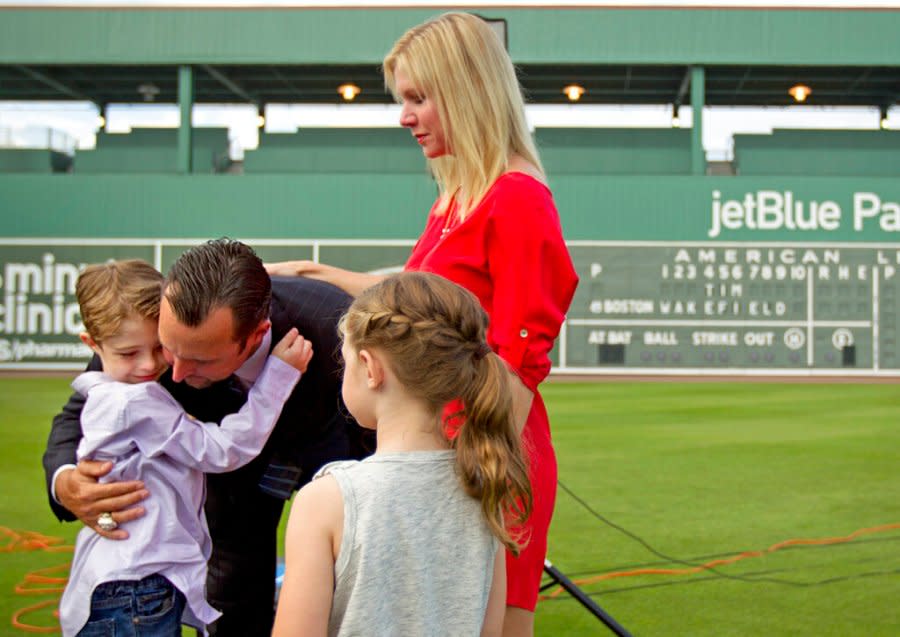 Boston Red Sox pitcher Tim Wakefield, center left, hugs his son, Trevor, 7, as his wife, Stacy, right, and daughter, Brianna, 6, look on after Wakefield announced his retirement from baseball during a news conference, Friday, Feb. 17, 2012, in Fort Myers, Fla. (AP Photo/David Goldman)