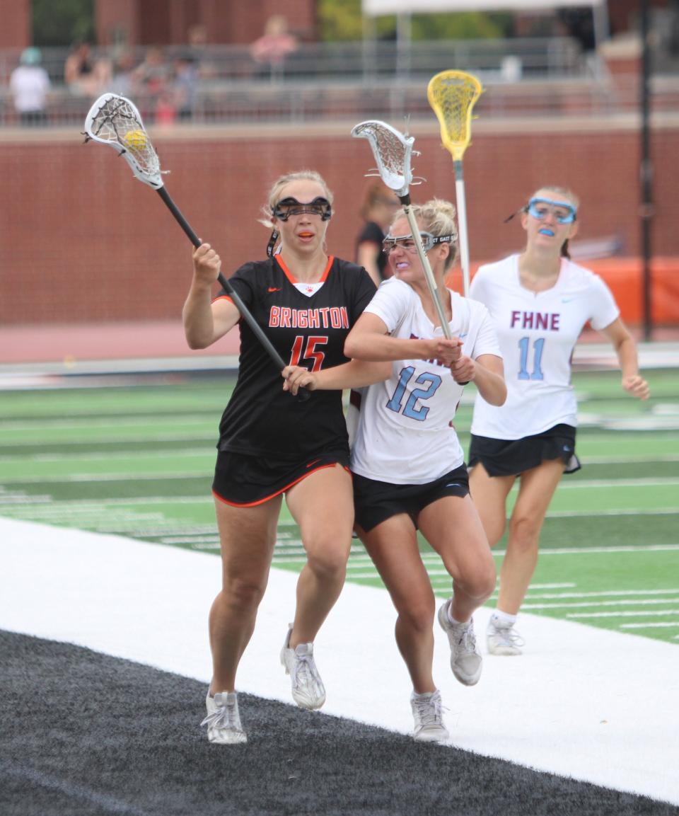 Brighton's Mya Nemecek (15) handles the ball while defended by Forest Hills Northern-Eastern's Alayna Davis during the state Division 1 girls lacrosse championship game Saturday, June 10, 2023 in Rockford.