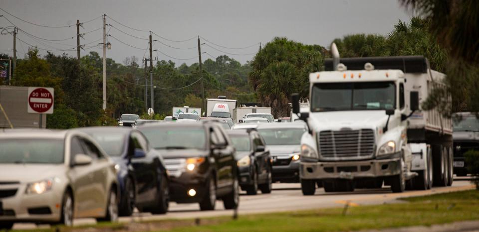 Traffic backs on Daniels Parkway in Fort Myers heading west towards I-75 during morning rush hour on Tuesday, Nov. 14, 2023.