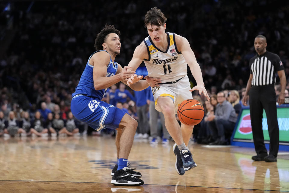 Marquette's Tyler Kolek (11) drives past Xavier's Desmond Claude (1) in the second half of an NCAA college basketball game for the championship of the Big East men's tournament, Saturday, March 11, 2023, in New York. (AP Photo/John Minchillo)