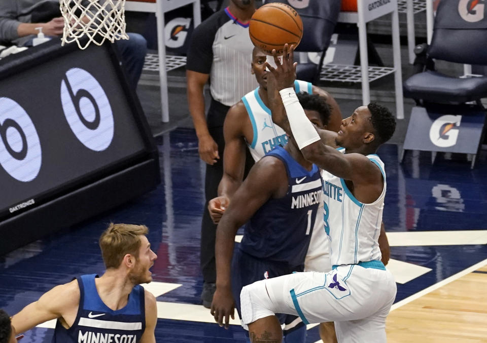 Charlotte Hornets' Terry Rozier, right, lays the ball up in front of Minnesota Timberwolves' Anthony Edwards (1) and Jake Layman, left, during the first half of an NBA basketball game Wednesday, March 3, 2021, in Minneapolis. (AP Photo/Jim Mone)