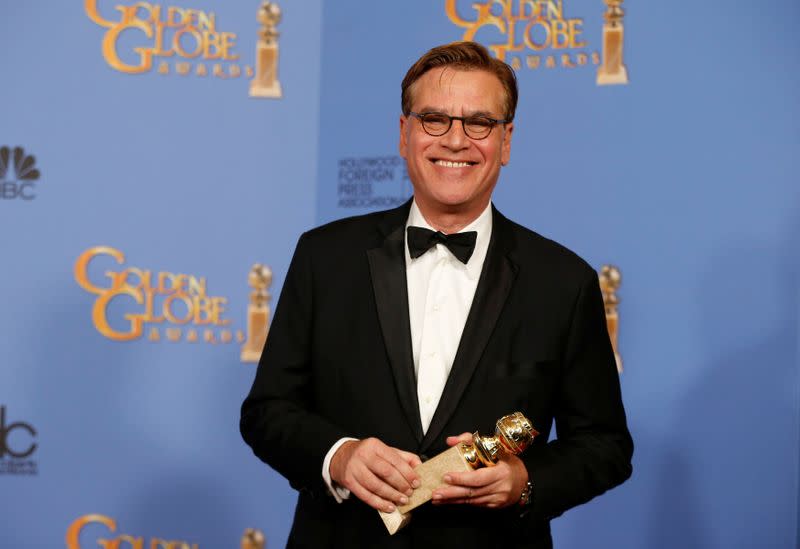 FILE PHOTO: Aaron Sorkin poses with the award for Best Screenplay - Motion Picture for "Steve Jobs" backstage at the 73rd Golden Globe Awards in Beverly Hills