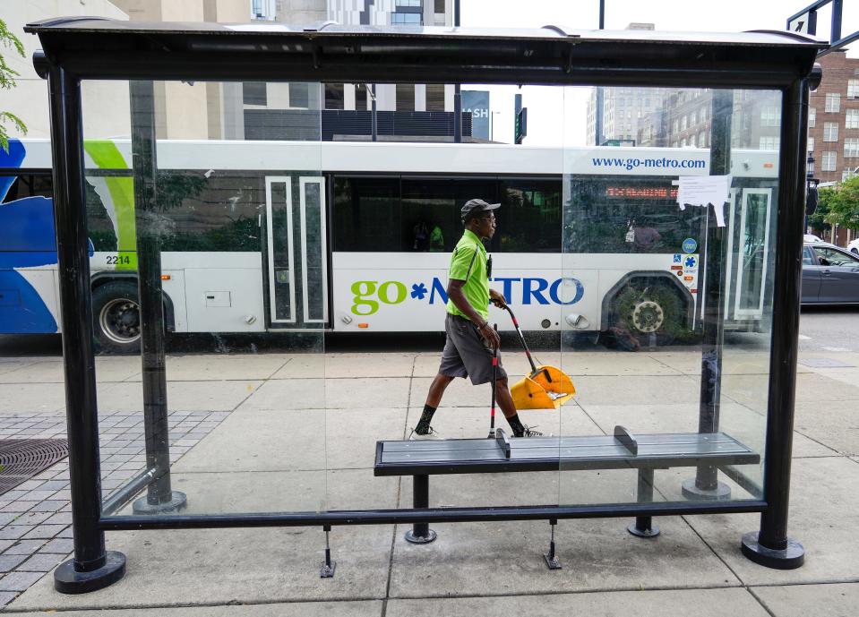 Lashun Woodard walks the blocks surrounding Court Street cleaning the sidewalks, performing business checks and answering questions from visitors and locals.