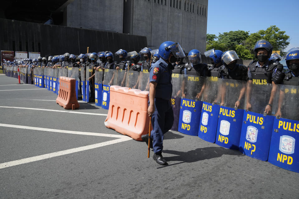 Police form a blockade against protesters during a rally against presidential frontrunner Ferdinand "Bongbong" Marcos and running mate Sara Duterte, daughter of the current president, during a rally in Pasay City, Philippines on Friday, May 13, 2022. Allies of the Philippines' presumptive next president, Ferdinand "Bongbong" Marcos Jr., appear set to strongly dominate both chambers of Congress, further alarming activists after the late dictator's son scored an apparent election victory that will restore his family to the seat of power. (AP Photo/Aaron Favila)