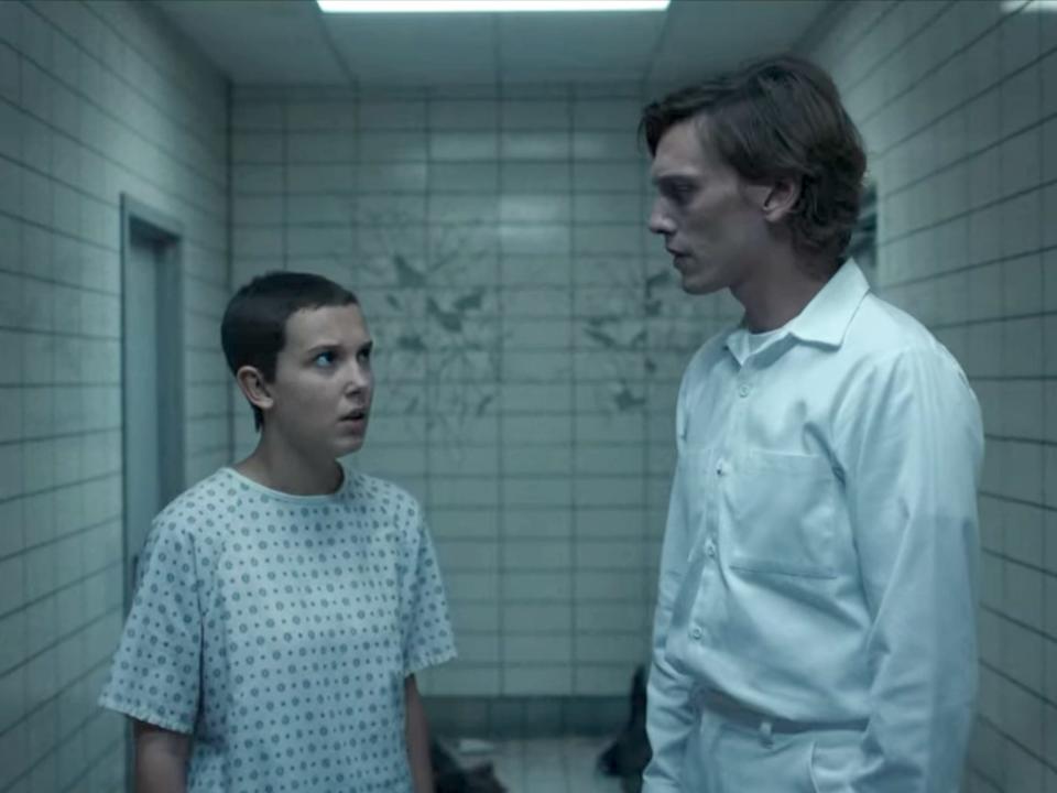 A young girl and 30-year-old man talking in the hallway.