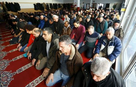 Men pray during Friday prayer service at the Abu Bakr mosque of the Islamic Islamic Community Cologne in the Zollstock suburb of Cologne January 8, 2016. REUTERS/Wolfgang Rattay