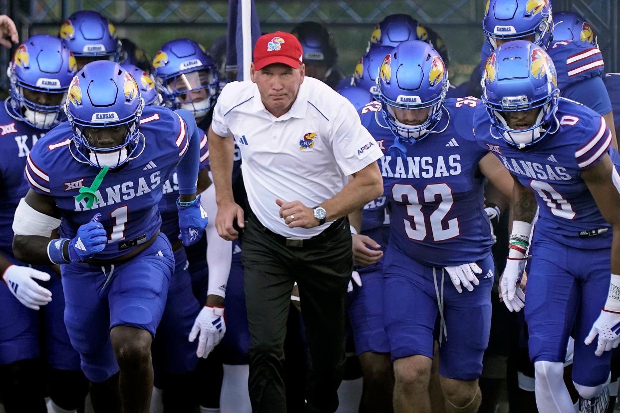 Kansas head coach Lance Leipold leads his team onto the field before an NCAA college football game against Missouri State Friday, Sept. 1, 2023, in Lawrence, Kan. (AP Photo/Charlie Riedel)