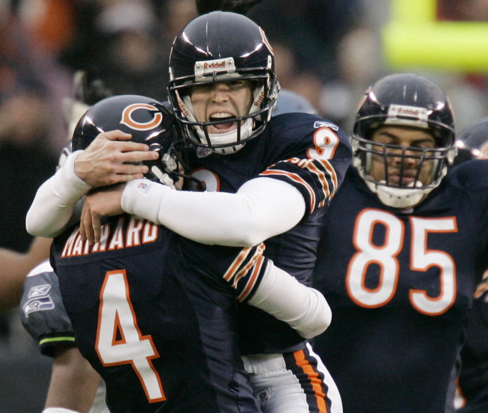FILE - Chicago Bears kicker Robbie Gould (9) and punter Brad Maynard (4) react after Gould kicked a 49-yard field goal to defeat the Seattle Seahawks, 27-24, in overtime in the NFC divisional playoff football game in Chicago, Sunday, Jan. 14, 2007. Gould, a Longtime NFL kicker, is retiring following an 18-year career that established himself as one of the game's best clutch kickers. (AP Photo/Jeff Roberson, File)